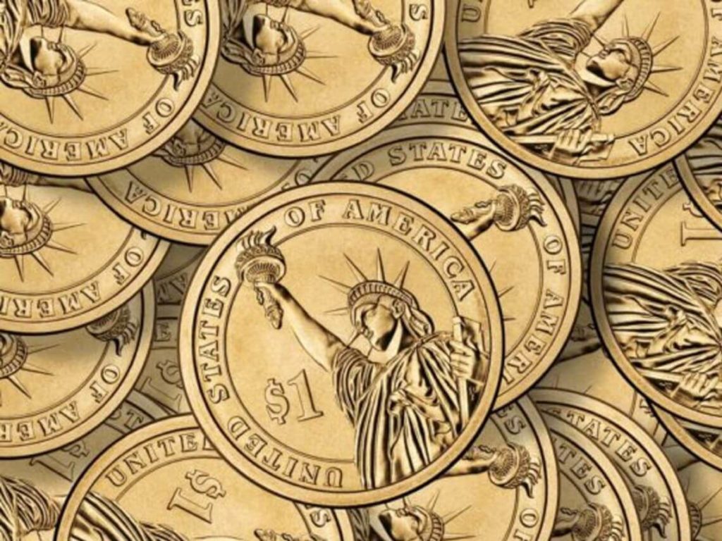A pile of $1 gold coins with lady liberty on them