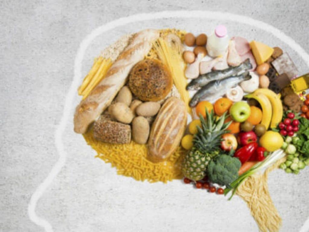Healthy foods are inside a drawn person's head to promote cognitive function
