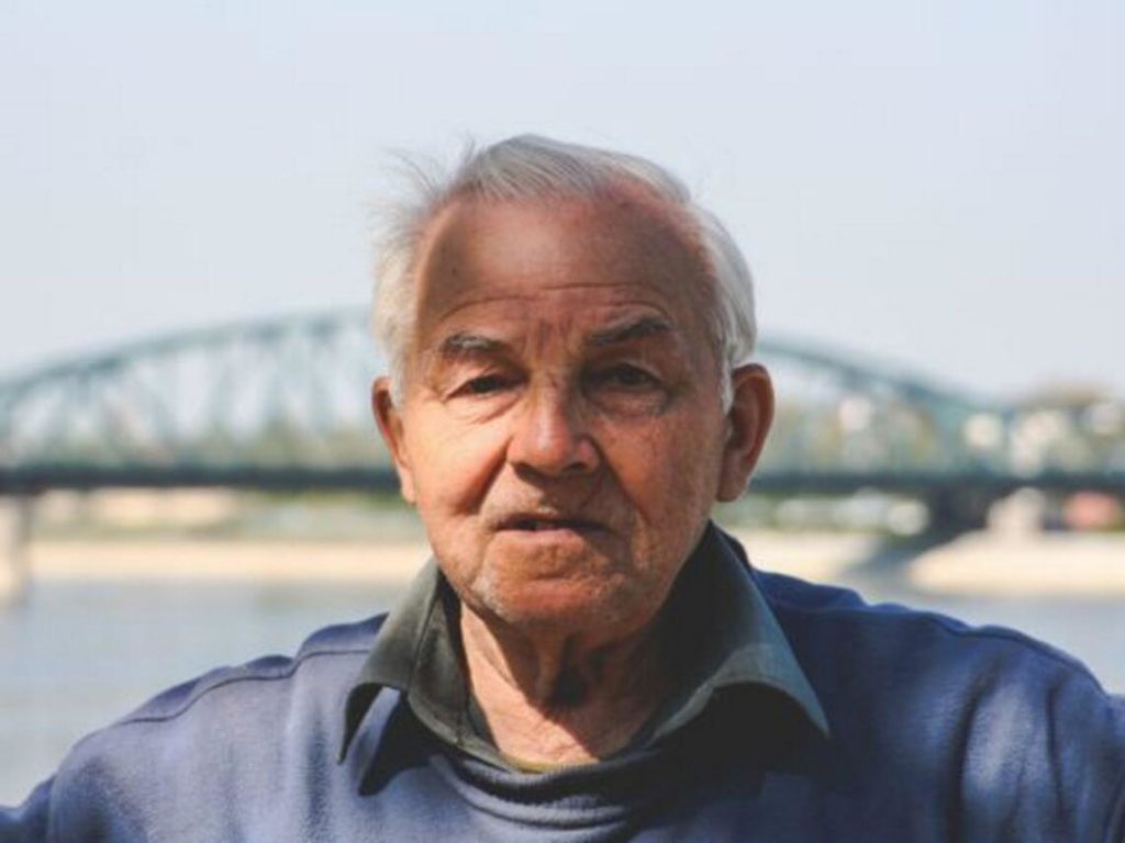 An elderly man taking a portrait. strokes