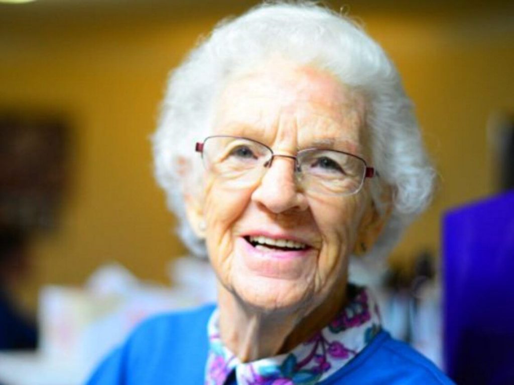healthy living elderly woman smiles at her Post-Acute Care facility