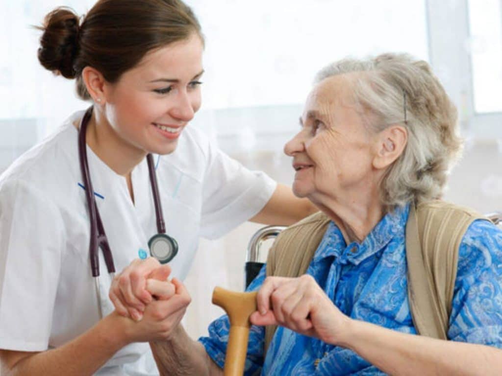 Senior woman is visited by her doctor or caregiver Healthcare worker and senior improved care services