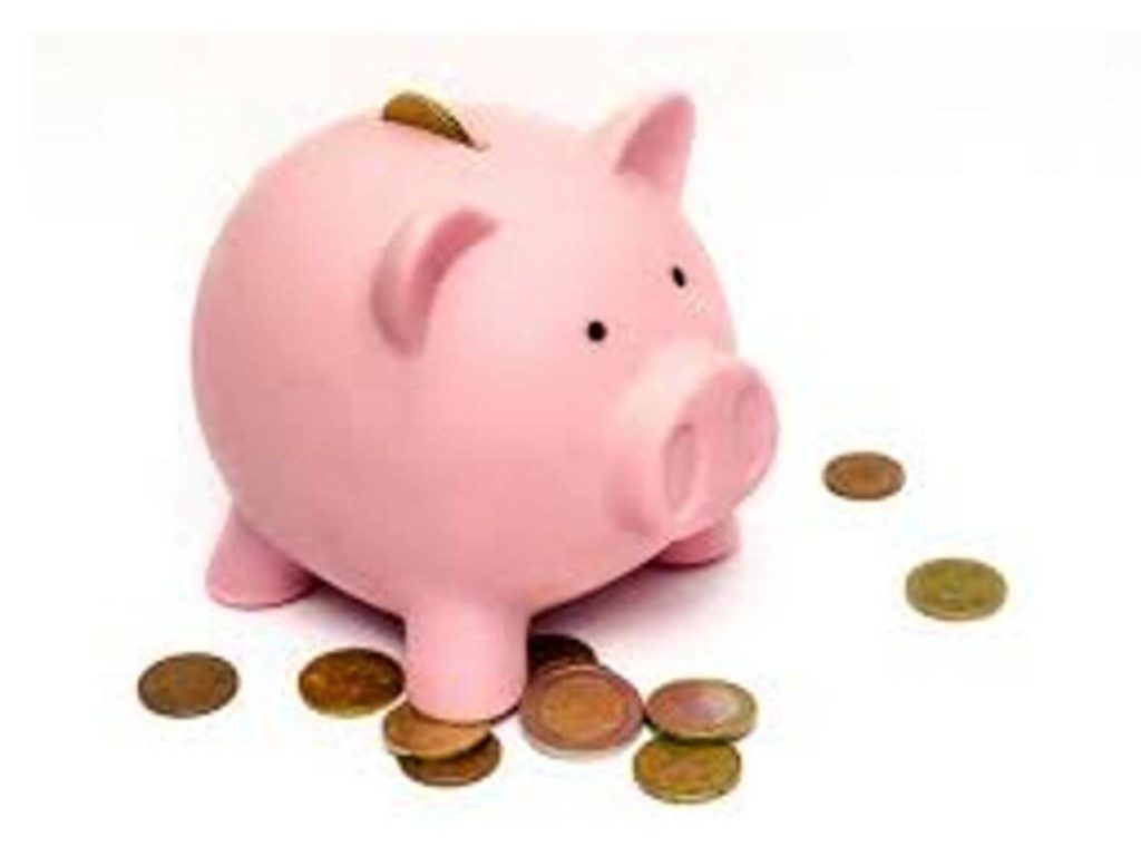 Pink piggy bank with coins Managing debt for seniors