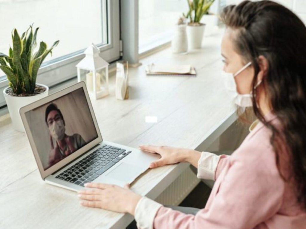 woman speaking to doctor over computer improve care telehealth technology