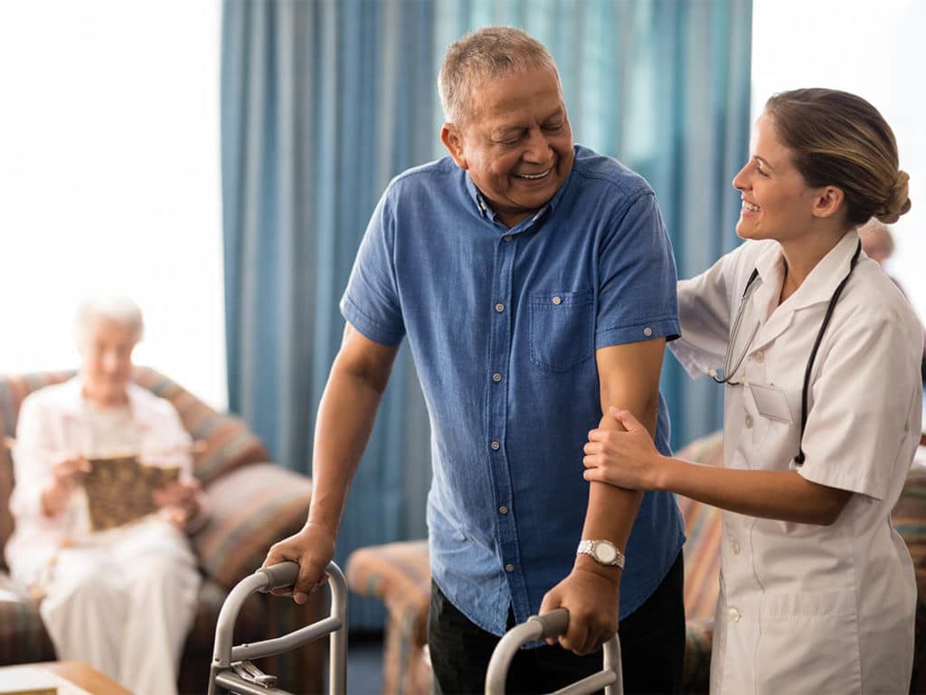 A person in post-acute care getting help from a nurse
