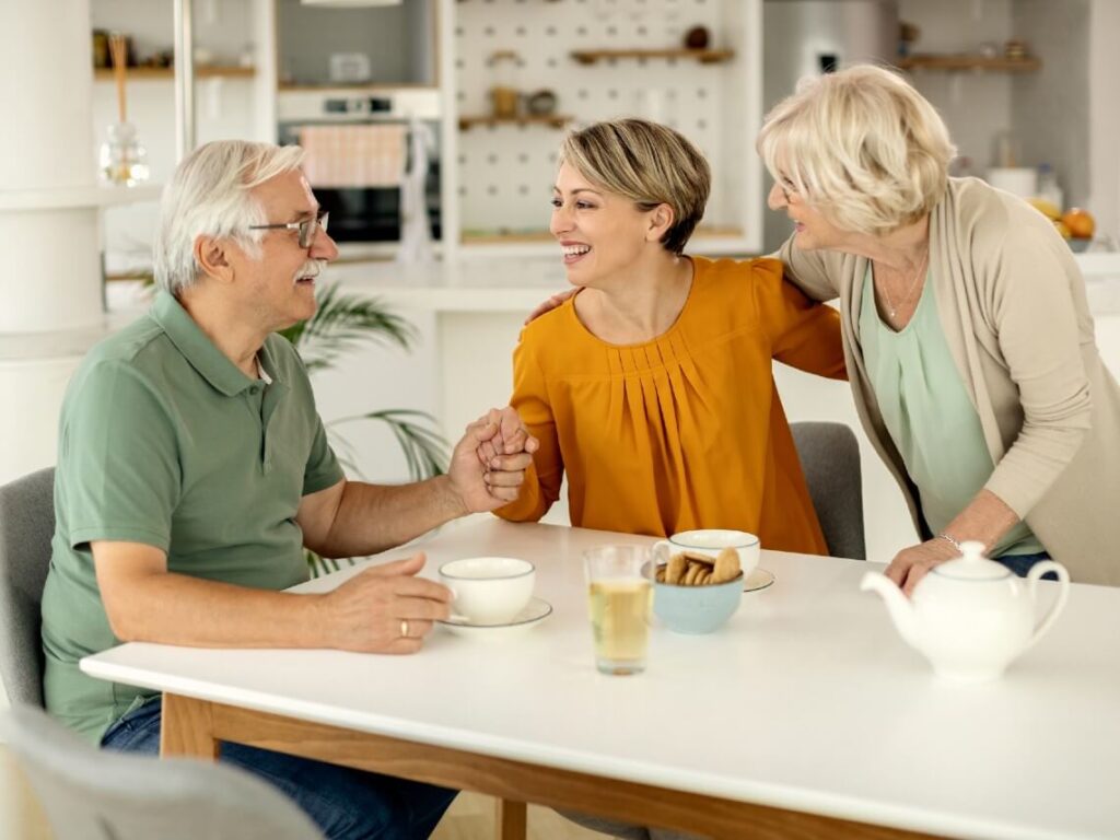 Happy woman talking to senior parents