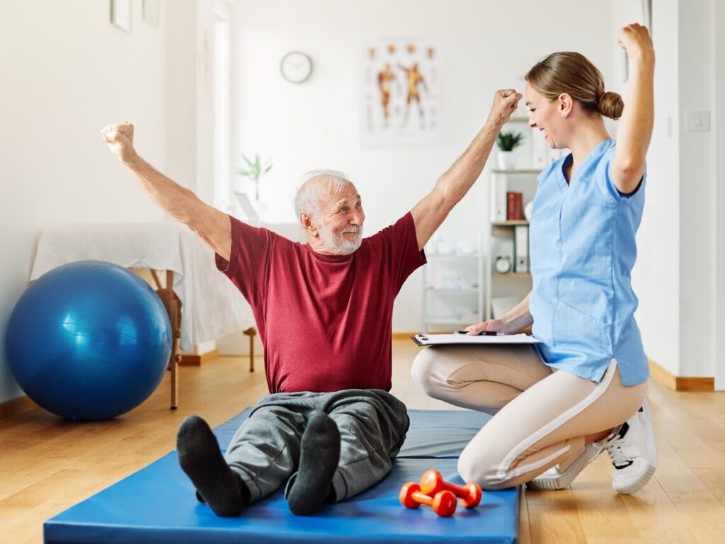 Physical therapist and senior patient cheering